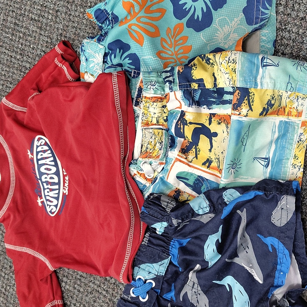 1 rash guard and 3 board shorts